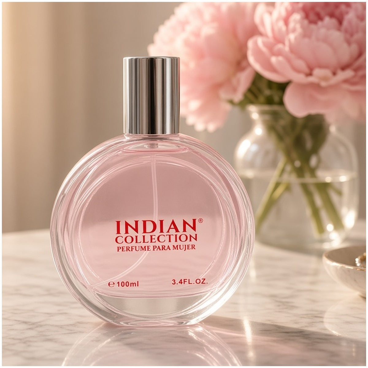 Perfume Indian Collection sobre un tocador de mármol con flores rosadas