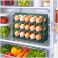 Organizador de huevos verde de 3 niveles dentro de la refrigeradora